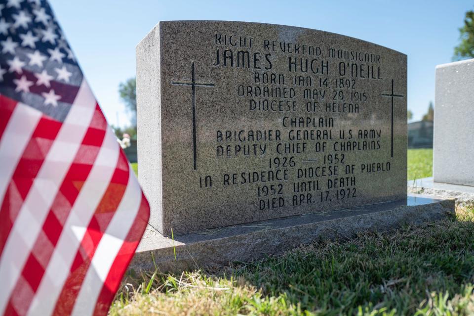 An American flag stands next to the grave marker of James Hugh O'Neill at Roselawn Cemetery on Thursday, May 26, 2022.