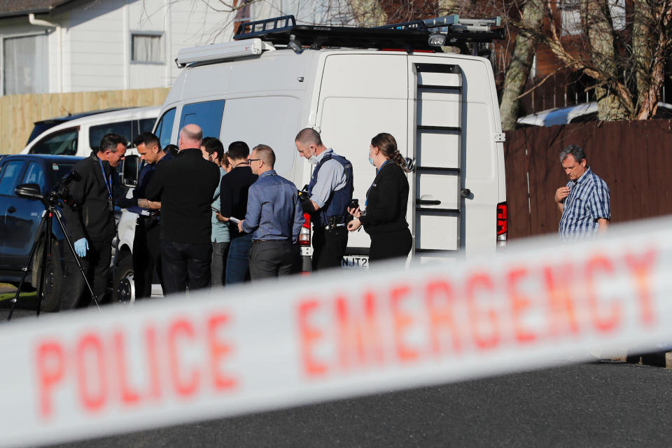 New Zealand police investigators work at a scene in Auckland on Aug. 11, 2022, after bodies were discovered in suitcases. A family who bought some abandoned goods from a storage unit in an online auction found the bodies of two young children concealed in two suitcases, police said Thursday, Aug. 18, 2022. (Dean Purcell/New Zealand Herald via AP)