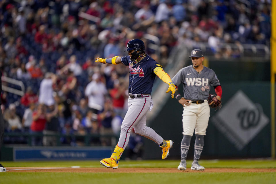 Atlanta Braves' Ronald Acuña Jr. celebrates as he runs the bases after hitting a solo home run during the first inning of a baseball game against the Washington Nationals at Nationals Park, Friday, Sept. 22, 2023, in Washington. With the hit, Acuña became the fifth player in MLB history with 40 home runs and 40 stolen bases in a season. (AP Photo/Andrew Harnik)