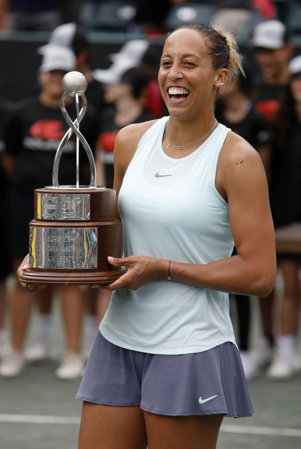 Madison Keys holds the championship trophy after defeating Caroline Wozniacki, from Denmark, to win their finals match at the Volvo Car Open tennis tournament in Charleston, S.C., Sunday, April 7, 2019. (AP Photo/Mic Smith)