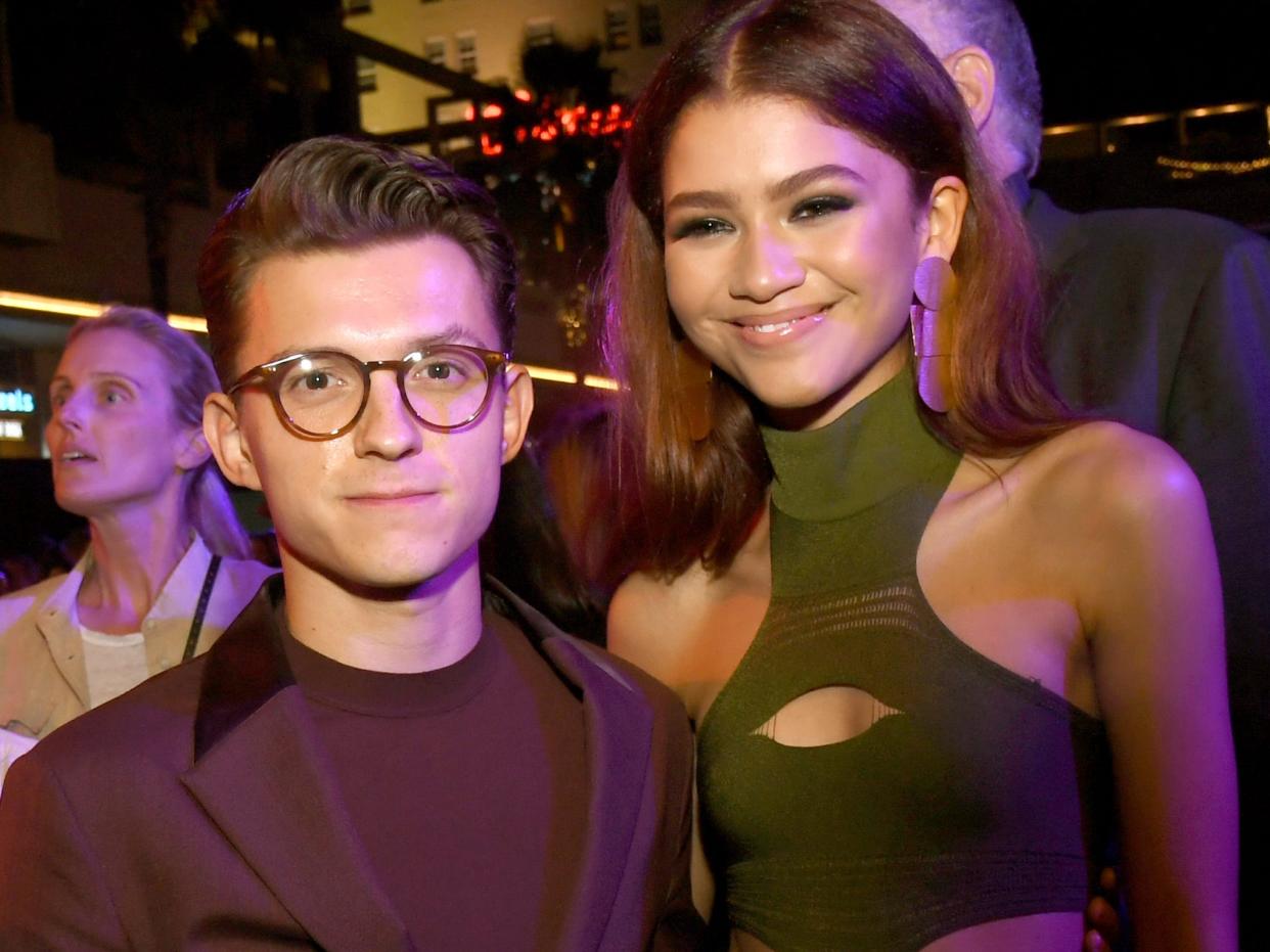 Tom Holland posing with Zendaya at the LA premiere of "Spider-Man: Far From Home" in June 2019.