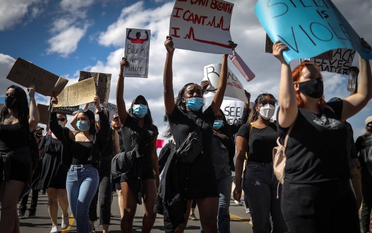 Calgarians turned out for a protest against police violence and racism following days of protests across the United States and Canada over the death of George Floyd in 2020.  (Leah Hennel/CBC - image credit)