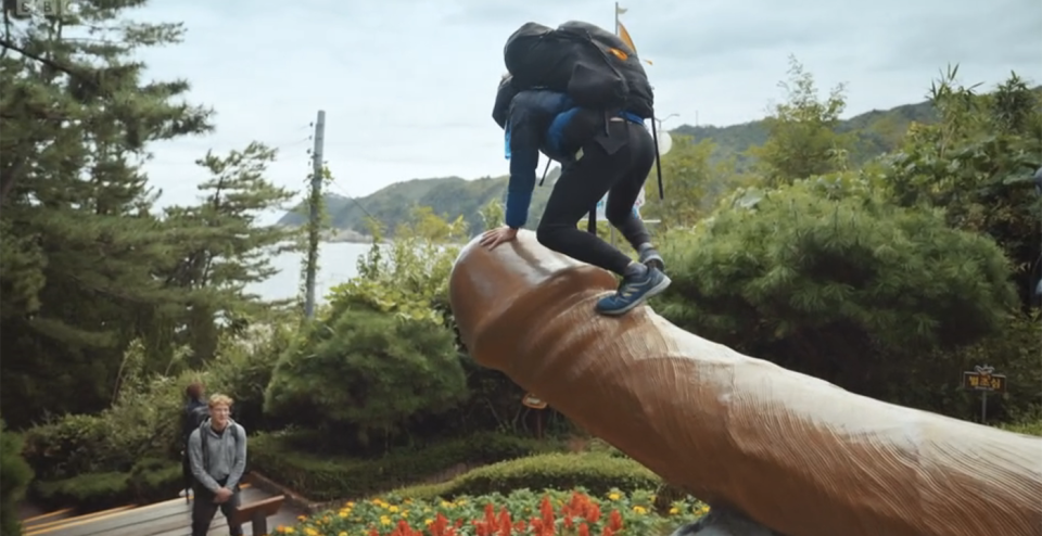 Race Across The World's Alfie climbed on one of the penis sculptures. (BBC screengrab)