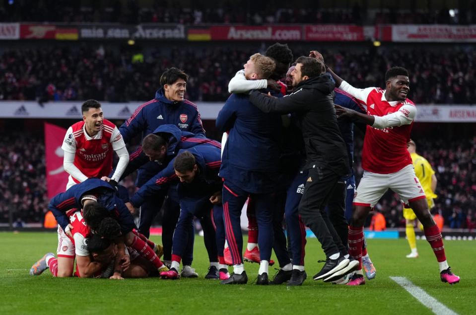 Arsenal players celebrate their sides third goal scored by Reiss Nelson during the Premier League match at the Emirates Stadium, London. (PA)