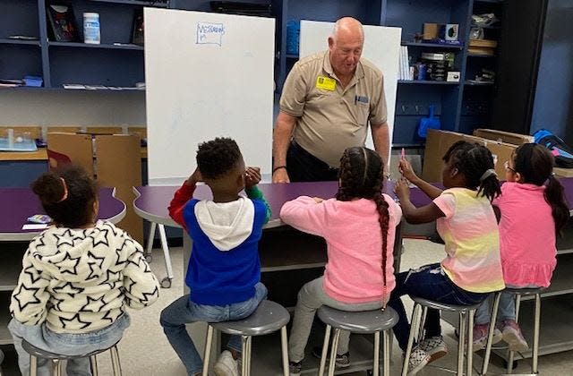 Donn Weaver of the Veterans Memorial Center talks to children about veterans in a session at Aspiration Academy, an afterschool program.