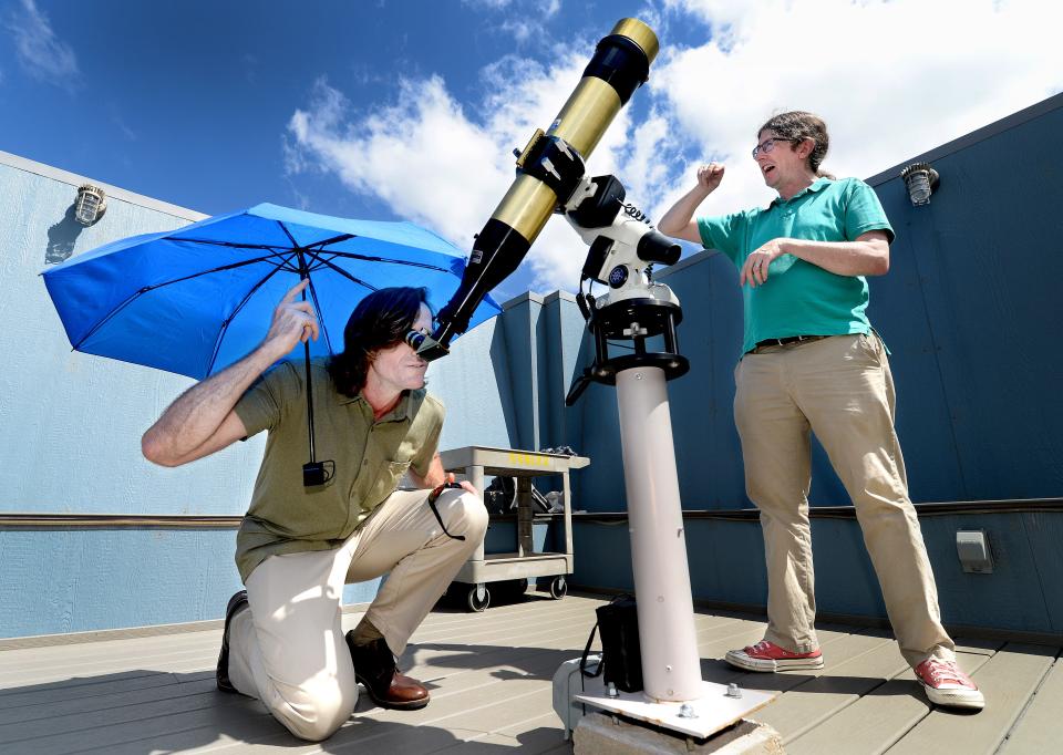 Associate professor of Astronomy and Physics at the University of Illinois Springfield John Martin, right, talks about the solar telescope being used by the Director for Military and Veteran Student Services  Loren Easter as they observe the sun on the roof of Brookens Library at UIS Thursday, August 31, 2023.