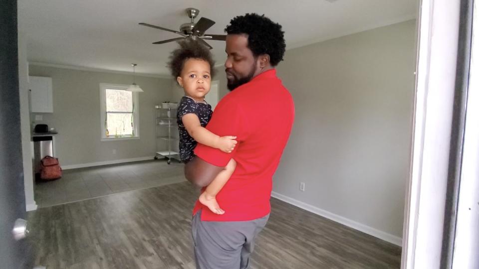 J.A. Moore holds his daughter Mariah