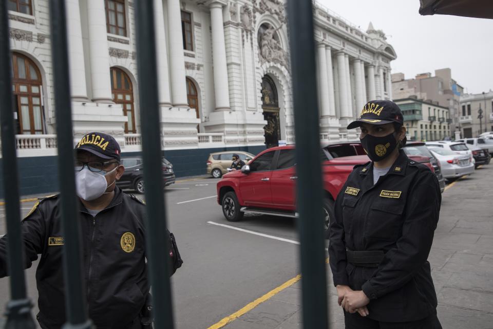 Police stand guard outside Congress in Lima, Peru, Friday, Sept. 18, 2020. Peruvian President Martin Vizcarra's job is on the line Friday as opposition lawmakers push through an impeachment hearing criticized as a hasty and poorly timed ouster attempt in one of the countries hardest hit by the coronavirus pandemic. (AP Photo/Rodrigo Abd)