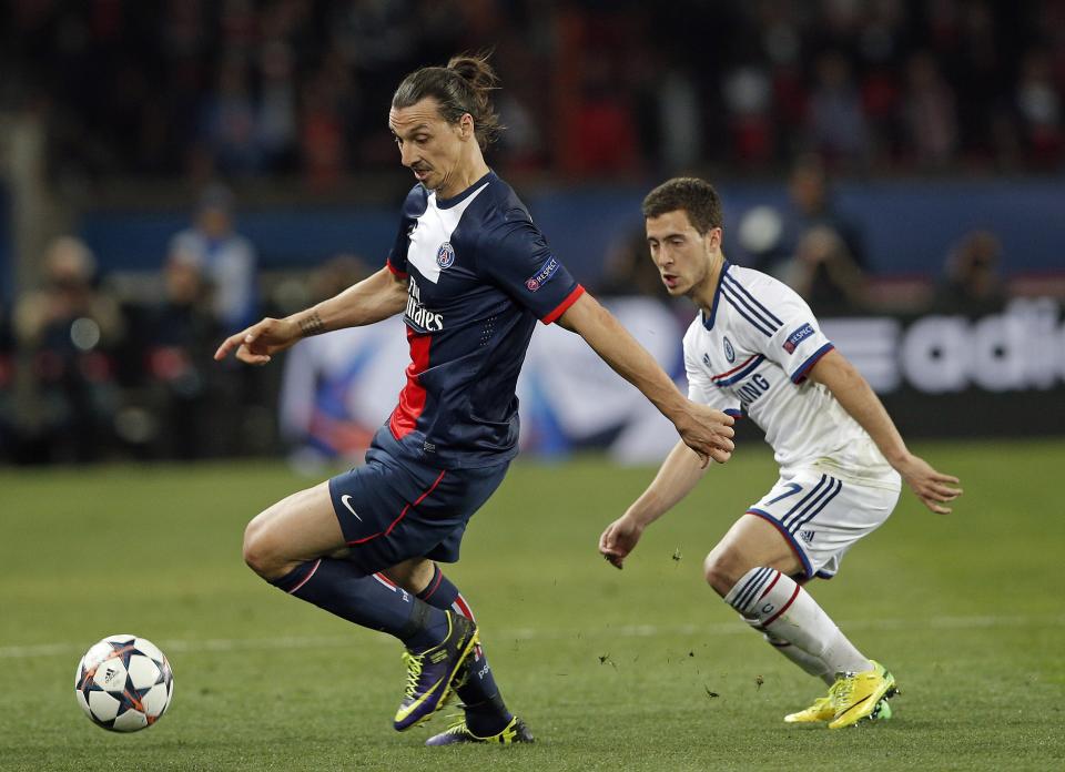 PSG's Zlatan Ibrahimovic, left, is challenged by Chelsea's Eden Hazard during the Champions League quarterfinal first leg soccer match between PSG and Chelsea, at the Parc des Princes stadium, in Paris, Wednesday, April 2, 2014. (AP Photo/Christophe Ena)