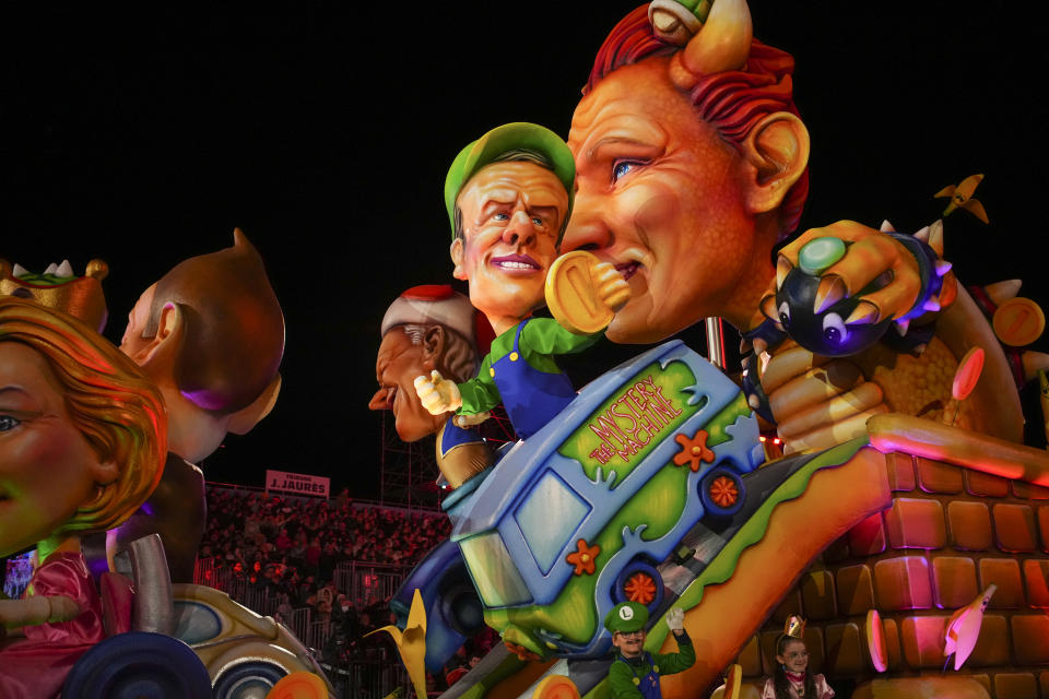 A carnival float depicting French President Emmanuel Macron parades through Place Massena during the opening ceremony of 151st edition of the Nice Carnival in Nice, southern France, Saturday, Feb. 17, 2024. (AP Photo/Daniel Cole)