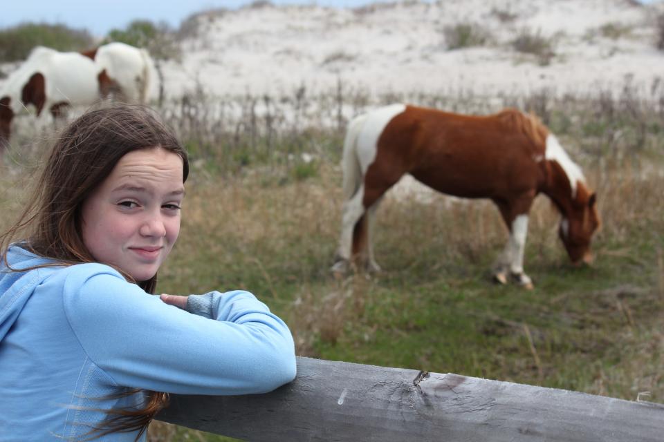 Zoe Newman with her first foster horse, Annie Laurie, during a recent trip to Assateague Island. Zoe recently became the first person to foster the entire Maryland herd of ponies.