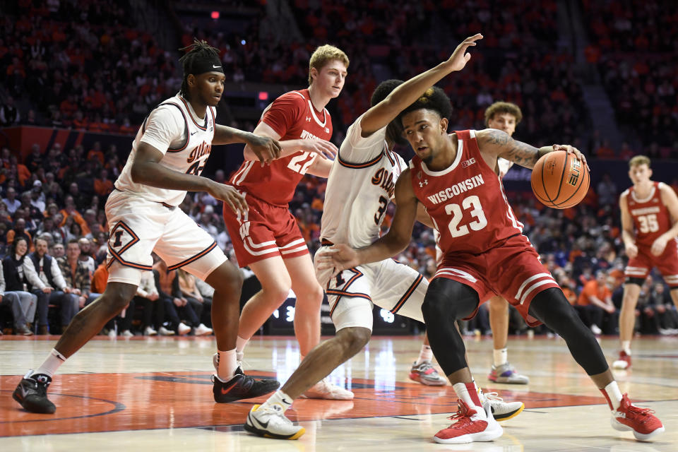 Wisconsin's Chucky Hepburn (23) works the ball inside against Illinois' Jayden Epps (3) during the second half of an NCAA college basketball game, Saturday, Jan. 7, 2023, in Champaign, Ill. (AP Photo/Michael Allio)