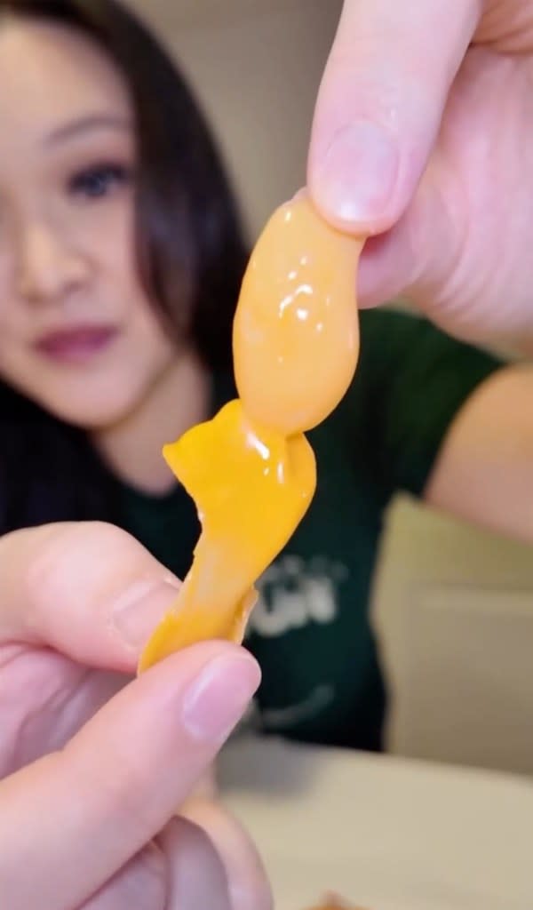 Peeling the candy is half the fun of eating it, fans say. TikTok / @trinhdoesthings