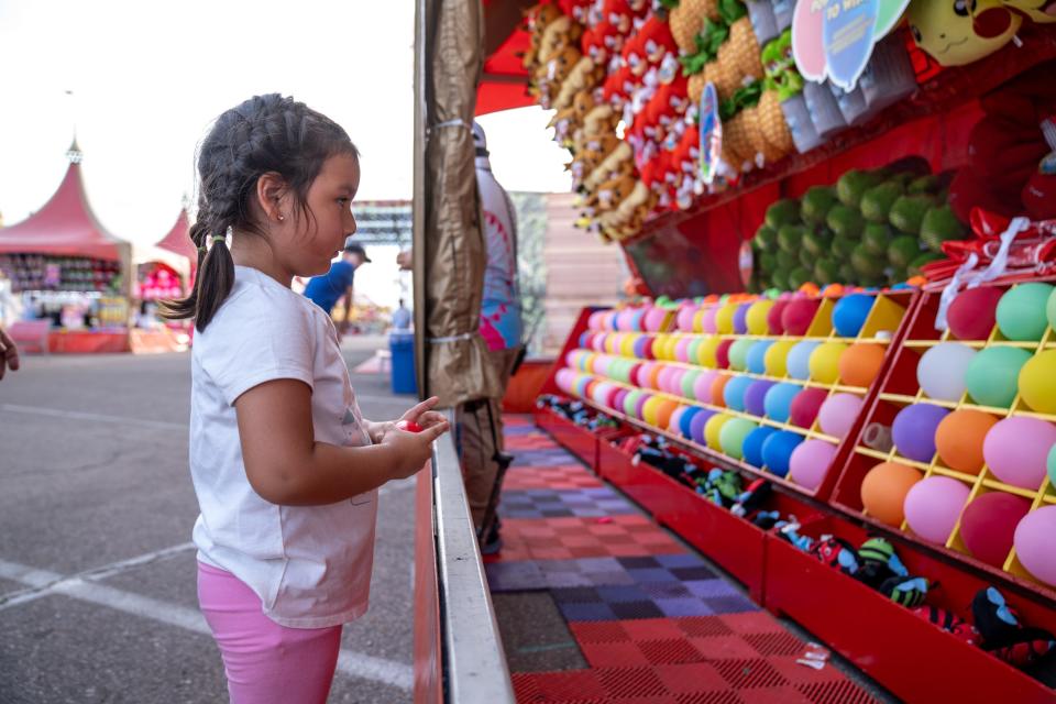 Itzel Cortez, 4, plays games at the Arizona State Fair in Phoenix on Sept. 22, 2023.