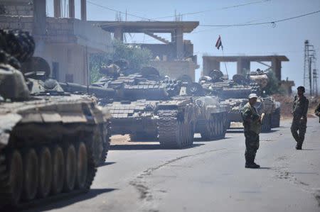 Forces loyal to Syria's President Bashar al-Assad are deployed in al-Ghariya al-Gharbiya in Deraa province, Syria in this handout released on June 30, 2018. SANA/Handout via REUTERS