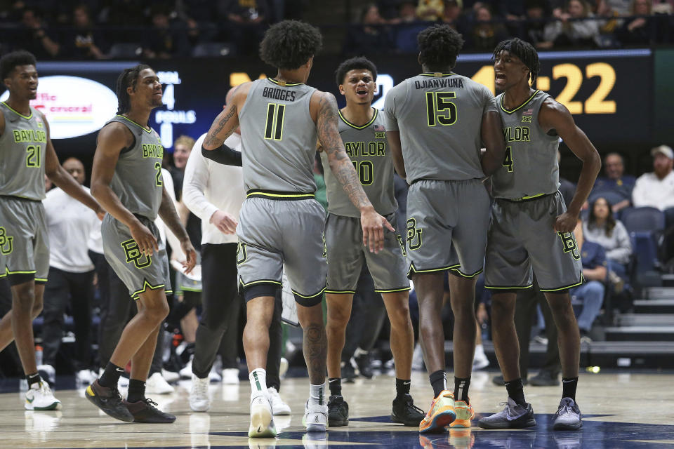Baylor players celebrate after a score against West Virginia during the first half of an NCAA college basketball game Saturday, Feb. 17, 2024, in Morgantown, W.Va. (AP Photo/Kathleen Batten)