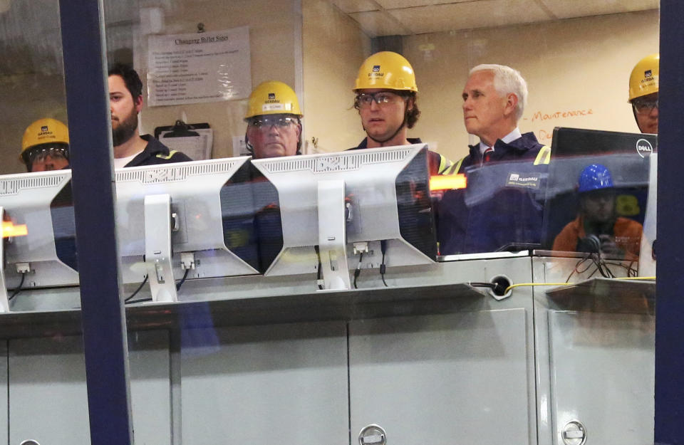 Vice President Mike Pence, right, tours the casting area pulpit at the Gerdau Ameristeel mill Thursday, May 9, 2019, in St. Paul, Minn. where he promoted the United States-Mexico-Canada Agreement. (AP Photo/Jim Mone)