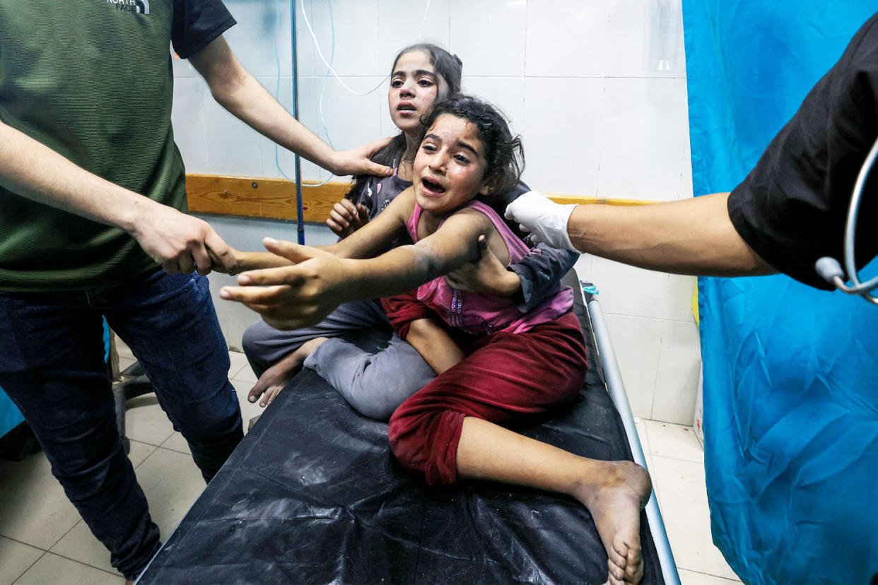 Injured children react as they receive treatment in the Nasser hospital in Khan Yunis in the southern of Gaza Strip on Oct. 17. (Mahmud Hams / AFP via Getty Images)