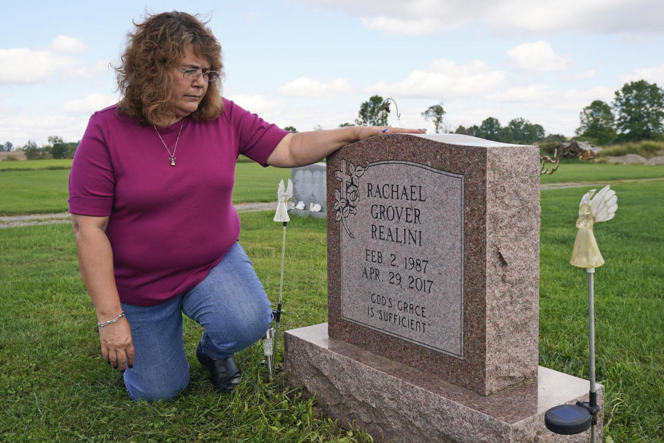 Sharon Grover looks at the grave of her daughter, Rachael, Tuesday, Sept. 28, 2021, in Mesopotamia, Ohio. Grover believes her daughter started using prescription painkillers around 2013 but missed any signs of her addiction as her daughter, the oldest of five children, remained distanced. (AP Photo/Tony Dejak)