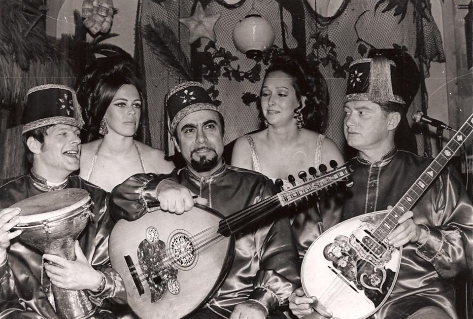 Guy Chookoorian, center, with his touring troupe of belly dancers and band.