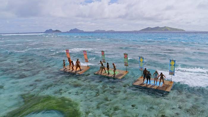 The participants steady themselves wooden stages floating in the sea