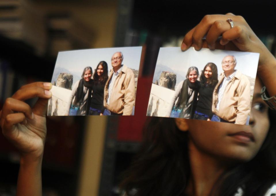 Photographs showing one of the passengers of the missing Malaysian Airlines aircraft Chandrika Sharma, left, her husband Narendran and daughter Meghna, are displayed during a press conference in Chennai, India, Wednesday, March 12, 2014. Narendran criticized the Indian government for its ‘silence’ and said no government official has contacted them on the incident yet, according to a local news agency. Malaysia has asked for India's assistance in searching for the missing Boeing 777 jetliner to widen the search to an area near the Andaman Sea, an Indian official said Wednesday. (AP Photo/Arun Sankar K)