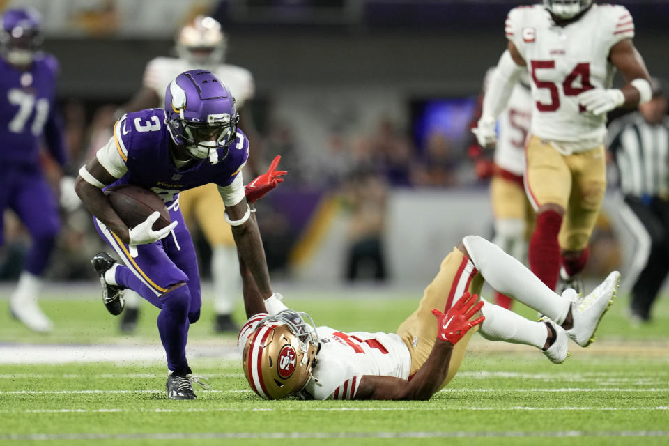 Minnesota Vikings wide receiver Jordan Addison (3) breaks a tackle by San Francisco 49ers cornerback Charvarius Ward (7) during a 60-yard touchdown reception in the first half of an NFL football game, Monday, Oct. 23, 2023, in Minneapolis. (AP Photo/Abbie Parr)