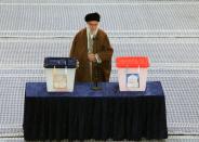 Iran's Supreme Leader Ayatollah Ali Khamenei casts his vote at a polling station during parliamentary elections in Tehran