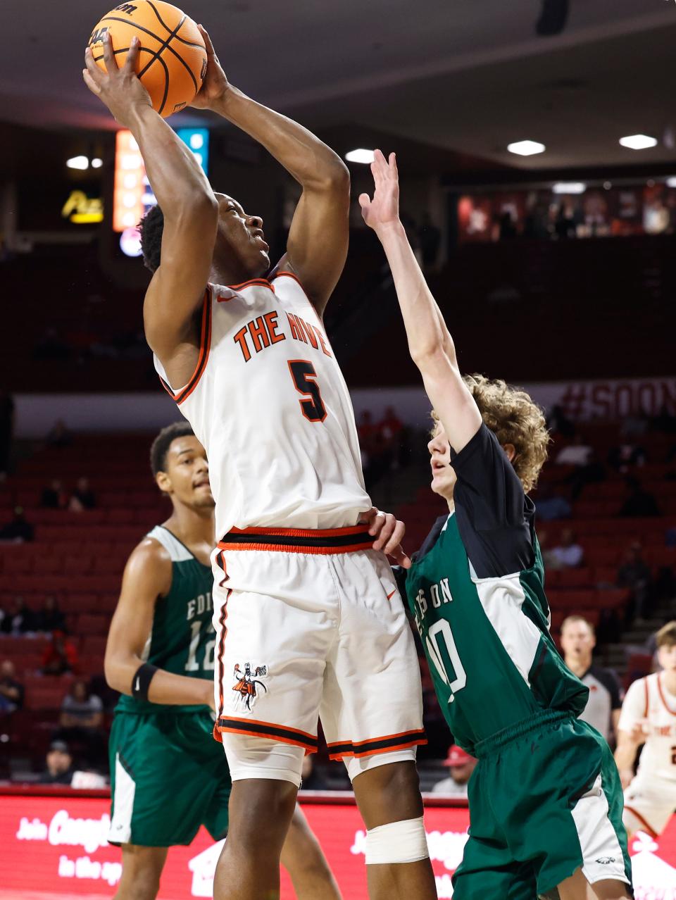 Booker T. Washington's Barron Harris shoots as Tulsa Edison's Jett Crawford defends during the second half of their 5A State Championship quarterfinal game at Lloyd Noble Center in Norman, Okla. on Thursday, March 7, 2024.