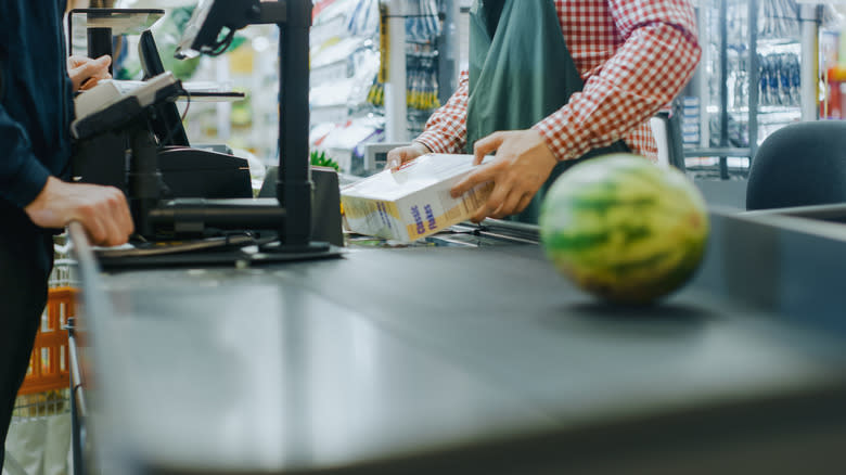 Cashier scanning grocery item