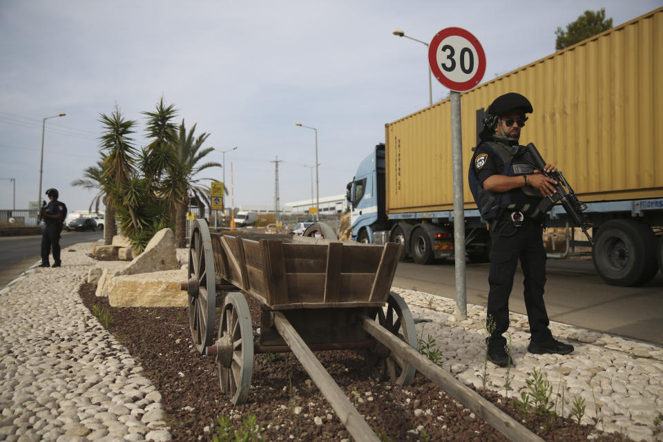 Israeli policemen stand at then entrance of Barkan industrial zone in the West Bank Sunday, Oct. 7, 2018. A Palestinian attacker opened fire at a joint Israeli-Palestinian industrial zone in the West Bank Sunday, killing two Israelis and seriously wounding a third, the military said. (AP Photo/Oded Balilty)