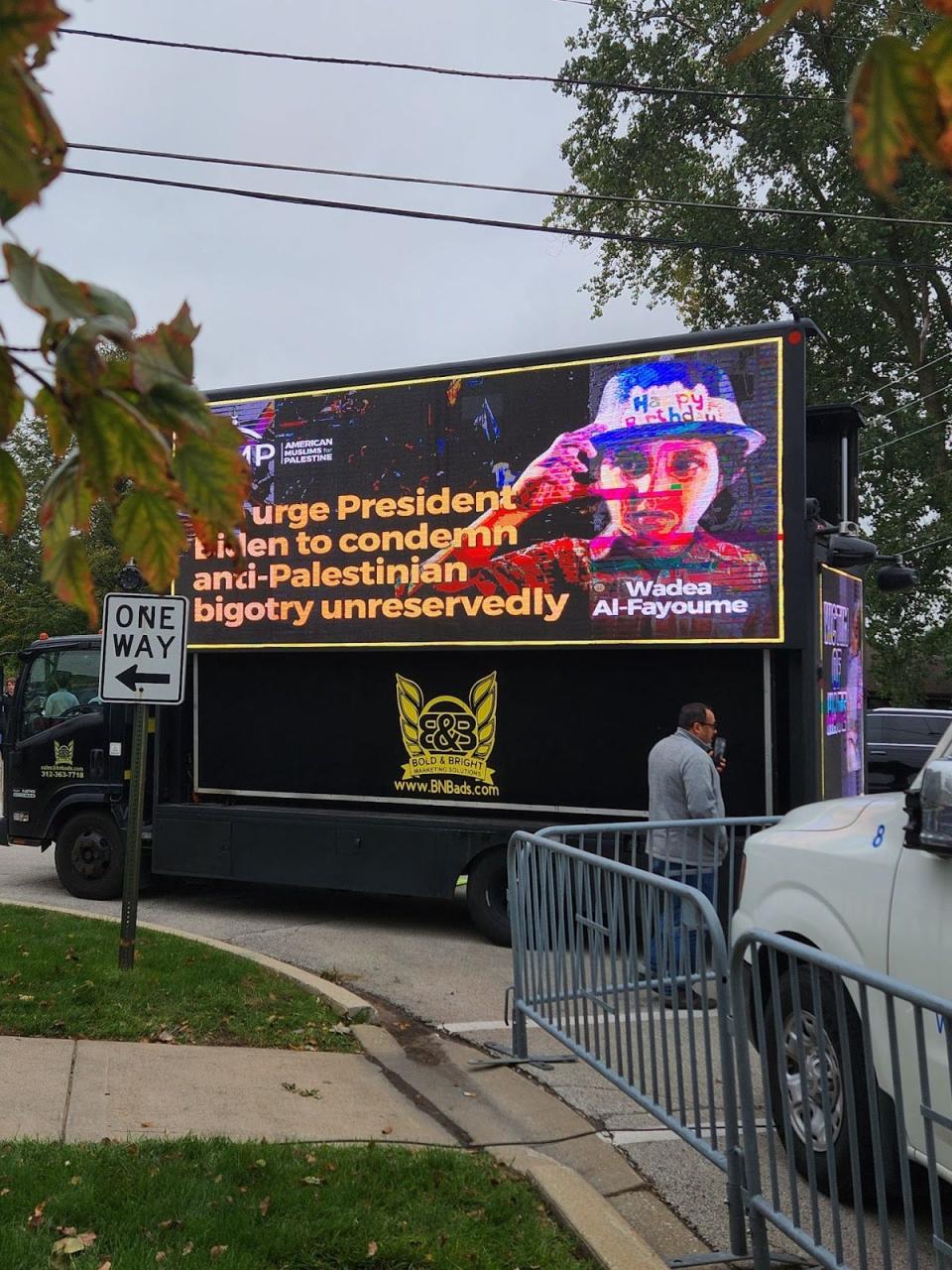 A mobile billboard projects a message outside the funeral of Wadea Al-Fayoume, a 6-year-old who was stabbed to death in a Chicago suburb. suspect has been charged with a hate crime, with authorities saying he was killed in a violent response to the Israel-Hamas war.