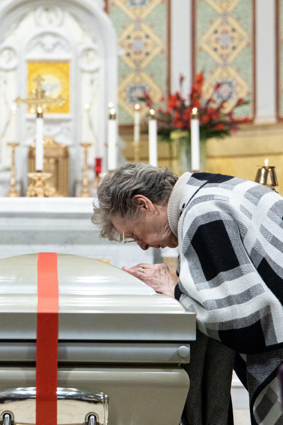 A person prays at the casket bearing the body of Blessed Stanley Rother during a prayer vigil on Sunday at Our Lady's Cathedral in Oklahoma City.