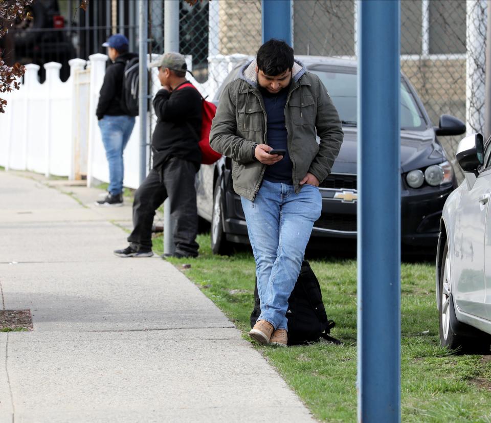 Day laborers seeking work, are pictured along Yonkers Avenue in Yonkers, April 12, 2023. 