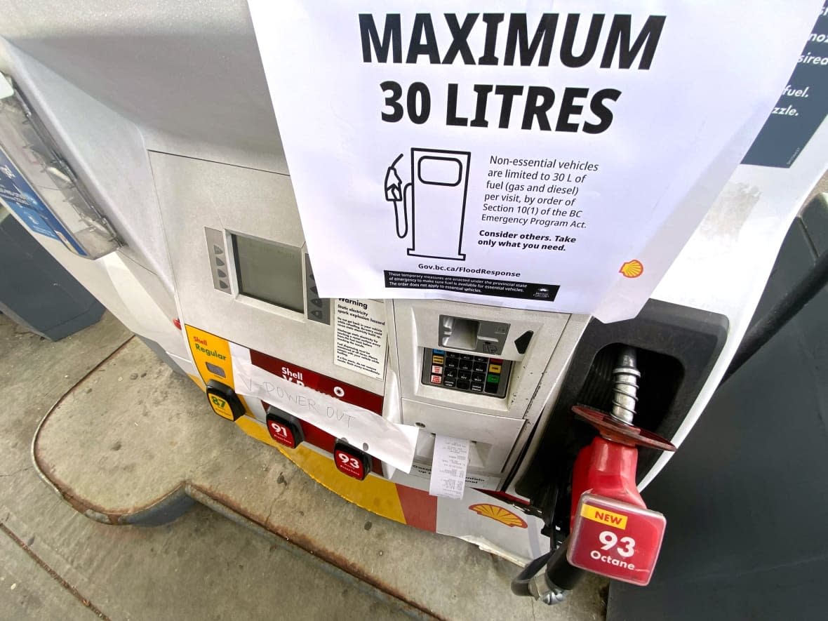 A sign noting a limit of 30 litres of gas for non-essential vehicles is shown at a gas station in Maple Ridge, B.C., on Nov. 21. (Jonathan Hayward/The Canadian Press - image credit)