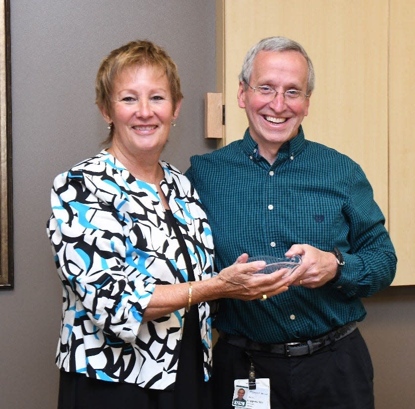 Charles Cappetta, MD, Dartmouth Health Children’s pediatrician and children’s health advocate (right), has been selected as the recipient of the 2022 Sandi Van Scoyoc Legacy Award by the New Hampshire Children’s Health Foundation. Cappetta was honored in a ceremony at Dartmouth Health’s regional administrative office in Bedford on Monday, June 6, where Gail Garceau, president of the New Hampshire Children’s Health Foundation (left), presented him with the award and a $2,500 check, which he donated to Court Appointed Special Advocates for Children New Hampshire.