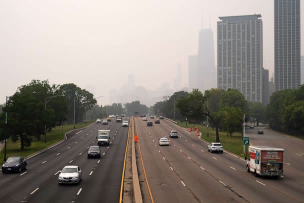 PHOTO: Cars pass through Lake Shore Drive as the downtown skyline is blanketed in haze from Canadian wildfires, June 27, 2023, in Chicago. (Kiichiro Sato/AP)
