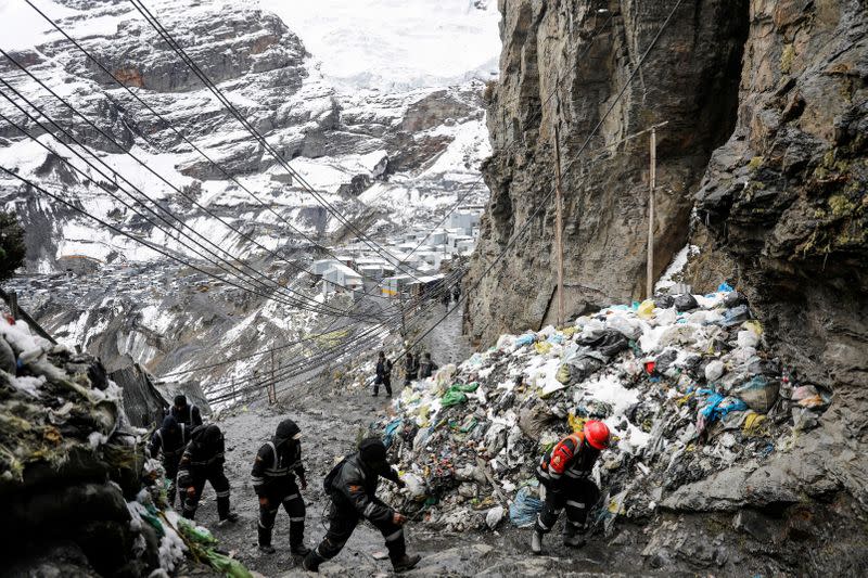 Artisanal gold miners leave a gold mine after their shift in La Rinconada, in the Andes