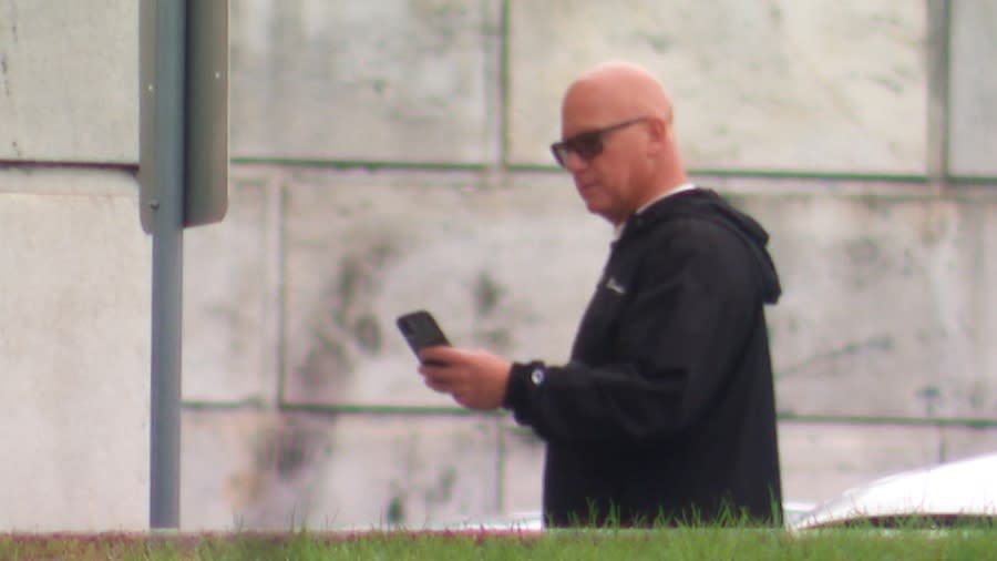 John Conti on his cell phone at the R.I. State House