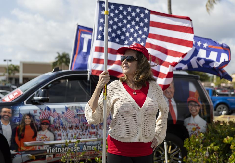 Amy Scott attends a rally for former President Donald Trump on Monday, April 3, 2023, in West Palm Beach, Fla. The supporters gathered to see Trump's motorcade as it headed to Palm Beach International Airport. (Matias J. Ocner/Miami Herald via AP)/Miami Herald via AP)