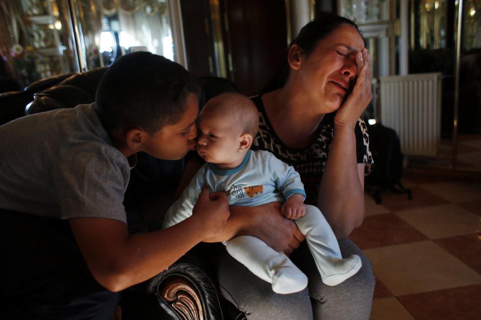 RNPS - PICTURES OF THE YEAR 2013 - Manuel Contreras, 11, kisses his niece Ainhoa, as his mother Carmen Acedo del Lago cries before learning that their eviction by the Municipal Housing and Land Company (EMVS) was postponed in Madrid June 4, 2013. Acedo del Lago, her husband, their five children, two sons-in-law and their four-month-old granddaughter have shared a social rental flat in northern Madrid since 2005. None of the adults in the family hold a steady job. The family fell behind on their monthly rent payments and were sent an eviction notice. "How can they evict a family for owing 463 euros ($605)?" says Acedo del Lago. In the end, the eviction was postponed by the EMVS until June 25. REUTERS/Susana Vera (SPAIN - Tags: SOCIETY REAL ESTATE BUSINESS TPX)