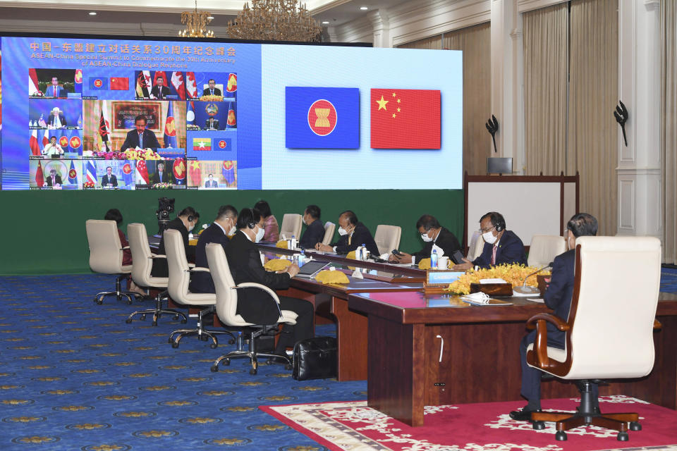 In this photo provided by the An Khoun Sam Aun/National Television of Cambodia, Cambodian Prime Minister, right, joins an online meeting of the ASEAN-China special summit at Peace Palace in Phnom Penh, Cambodia, Monday, Nov. 22, 2021. Despite regional frictions, Chinese leader Xi Jinping says his country will not seek dominance over Southeast Asia or bully its smaller neighbors. Xi made the remarks Monday during a virtual conference with the 10 members of the Association of Southeast Asian Nations, known as ASEAN, marking the 30th anniversary of relations between the sides. (An Khoun SamAun/National Television of Cambodia via AP)