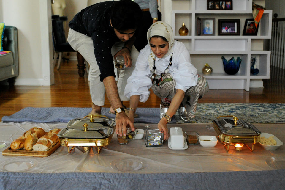 Yemeni-American Muslim Abdul Udayni (L) helps his sister Hajar Udayni prepare a breakfast feast to celebrate the Eid al-Fitr holiday in Brooklyn, New York, U.S., on June 25, 2017.&nbsp;