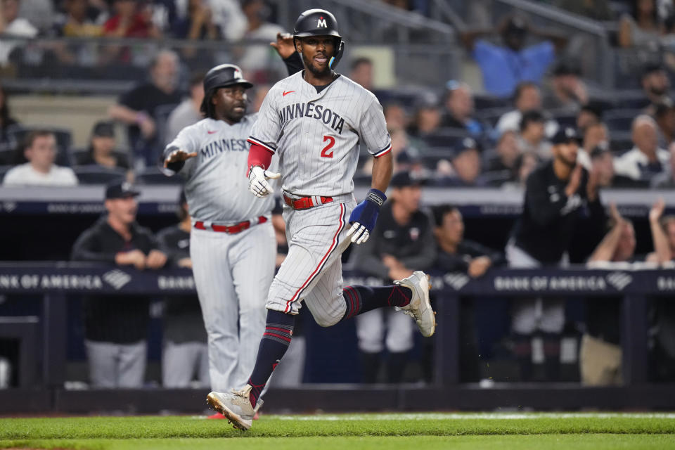Minnesota Twins' Michael A. Taylor (2) scores on a two-run double by Carlos Correa during the eighth inning of the team's baseball game against the New York Yankees on Friday, April 14, 2023, in New York. (AP Photo/Frank Franklin II)