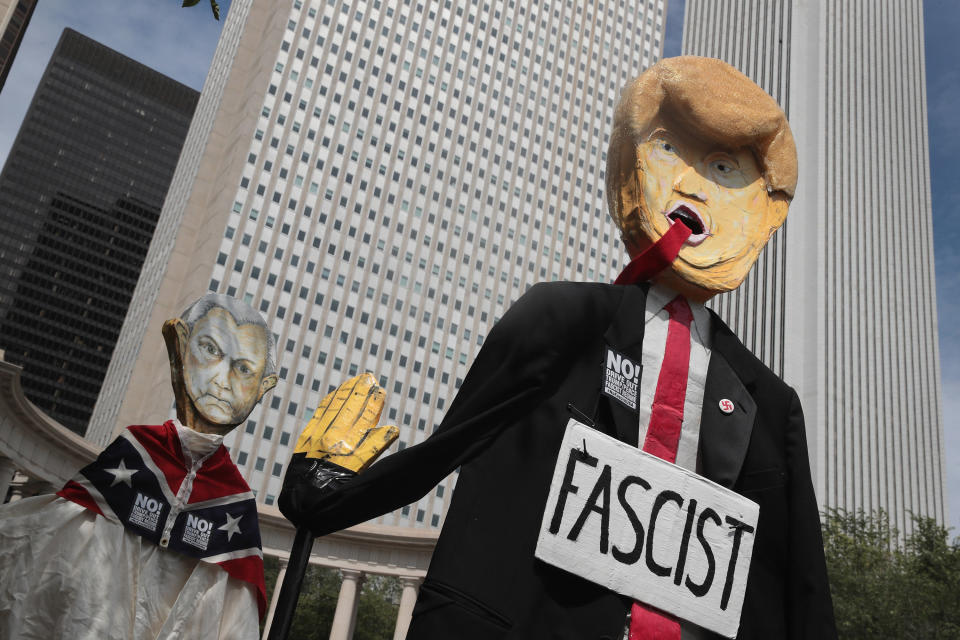 Demonstrators in Chicago protesting the alt-right and mourning Charlottesville, Virginia, victims carry puppets of President Donald Trump and U.S. Attorney General Jeff Sessions&nbsp;on Aug. 13. (Photo: Scott Olson via Getty Images)