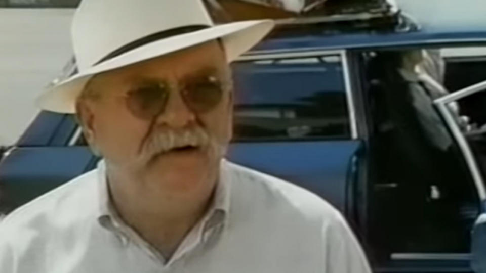 A close up of Wilford Brimley wearing a hat and sunglasses.