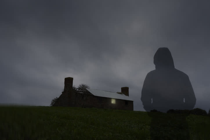 shadow of a figure looking towards a house