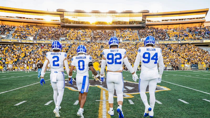 BYU's team captains walk to the pregame coin toss against Wyoming on Sept. 15, 2024 in Laramie.