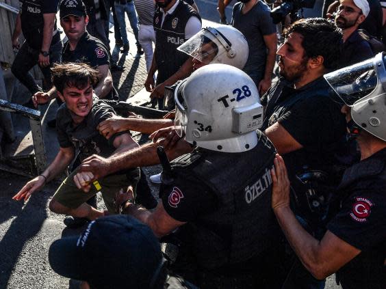 Riot police beat an LGBT+ rights activist after Turkish authorities banned last July’s event for a fourth year in a row (Getty)
