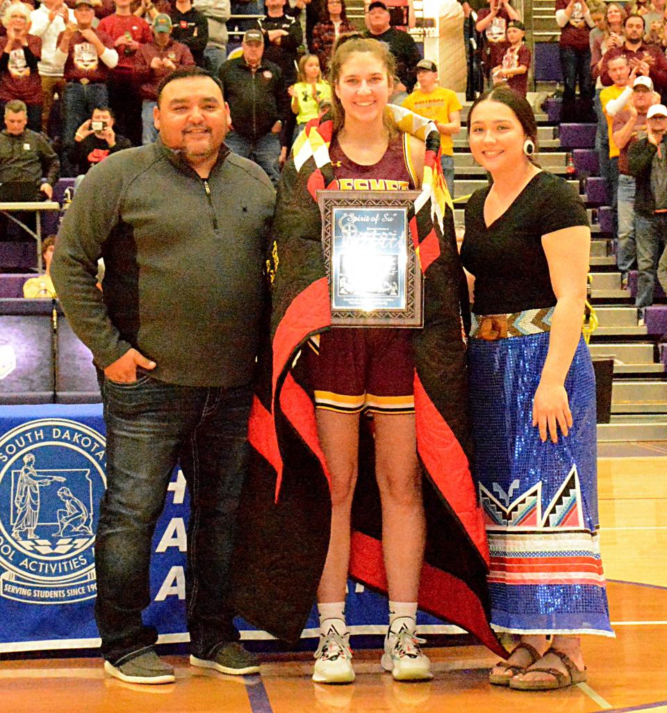 De Smet High School senior Kennadi Buchholz (center) received the Spirit of Su Award Saturday night in the state Class B girls basketball tournament at Watertown. Pictured with Buchholz are Christian "Tuffy" Morrison (left) and Remedy Morrison of the Visions of SuAnne Big Crow, Inc. The award is presented in honor of Big Crow.